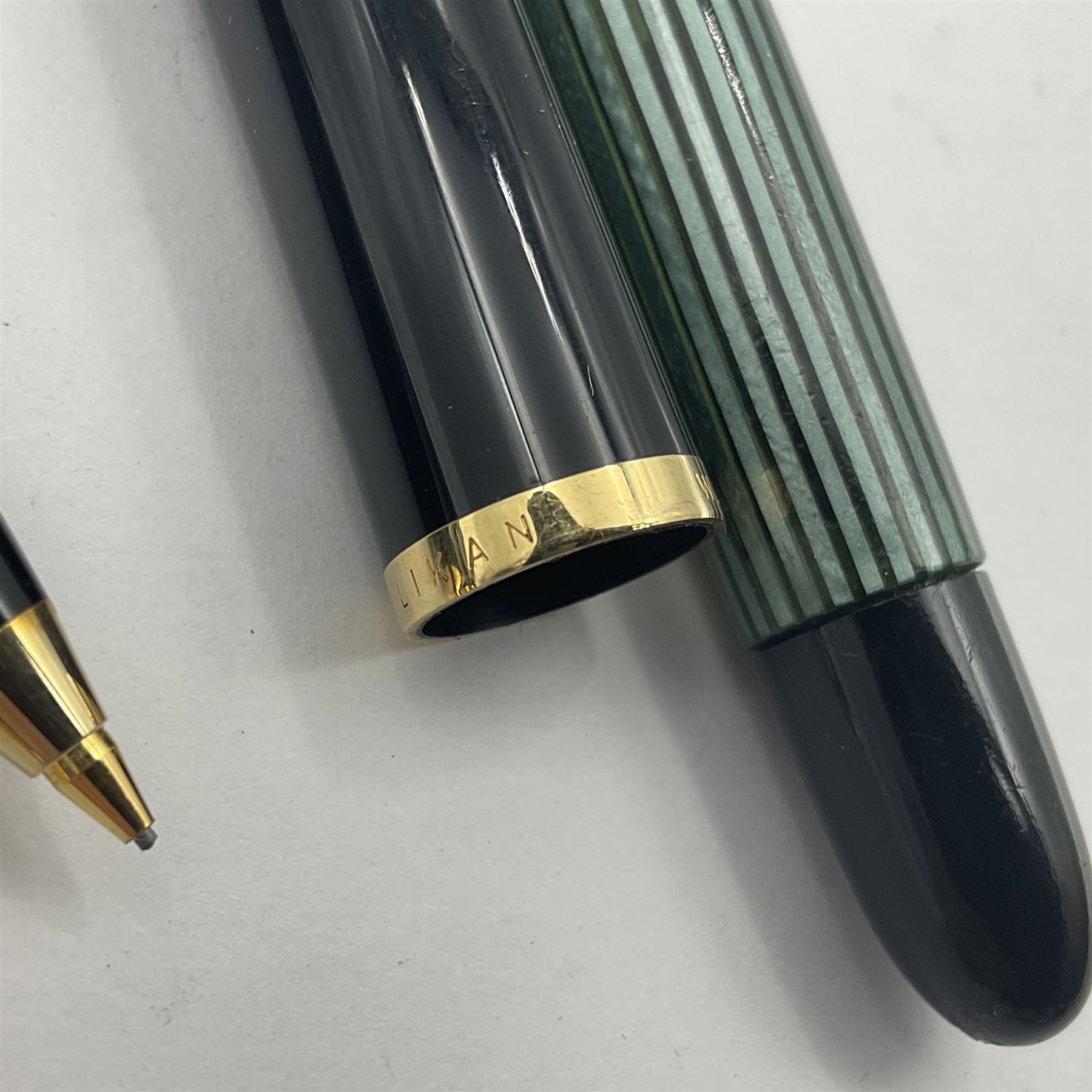 Pelikan Souveran 140 fountain pen, the green and black striped barrel with gold plated beak shaped clip and bands, with gold nib stamped 14C-585, together with matching twist ballpoint pen, push ballpoint pen and propelling pencil, largest approx L13.5cm (4)