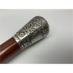 Victorian silver topped walking cane, possibly Anglo Indian, with chased petal design to top, the sides embossed with crowned vacant cartouche surrounded by foliate scrolls, unmarked, upon a Malacca shaft, L94cm