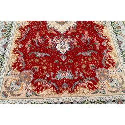 Fine Persian silk inlaid crimson ground Tabriz rug, the shaped field decorated with a central foliate pole medallion filled and surrounded by finely knotted floral motifs and trailing foliage, the cyan guard stripe with bold festoons and palmette motifs