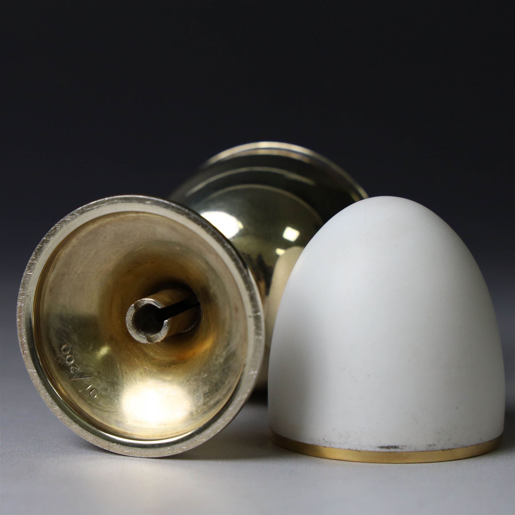Late 20th century silver-gilt novelty surprise egg by Anthony Gordon Elson, the egg cup containing a  removeable shell, lifting to reveal a parcel gilt egg basket beneath, hallmarked Anthony Gordon Elson, London 1979, H11cm