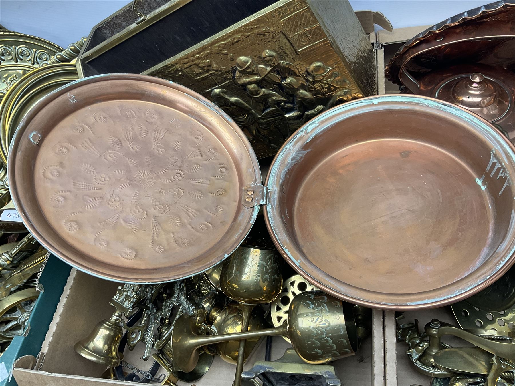 Quantity of copper pans and teapots, dish and sieve with pierced heart decoration and brass handle, together with quantity of brassware to include brass Art Nouveau crumb tray and brush, repousse chargers, fire tool accessories, decorative canon, sword and guns etc