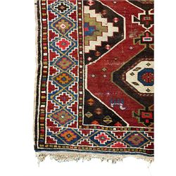 Anatolian Turkish red ground rug, decorated with three central lozenges, the multi-colour guarded border with repeating geometric shapes