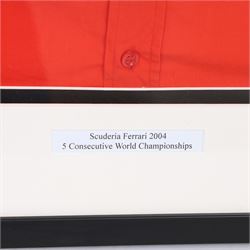 Scuderia Ferrari 2004 shirt, bearing four signatures including Michael Schumacher and Rubens Barrichello, to commemorate five consecutive World Championship wins, in glazed frame, frame H85cm