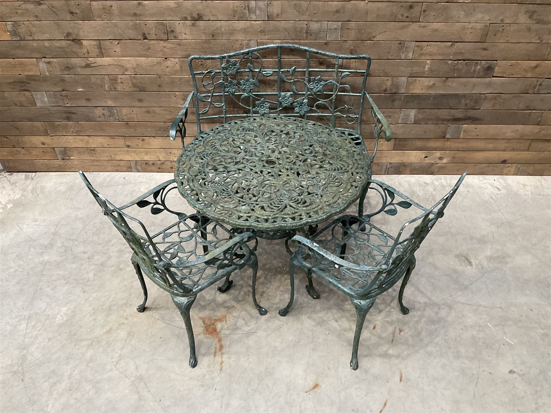 Cast aluminium garden dining set, comprising ornate circular table (D91cm, H68cm) a two seater bench, on cabriole supports (W118cm, H93cm, D55cm), and two matching armchairs (W55cm, H95cm, D54cm)