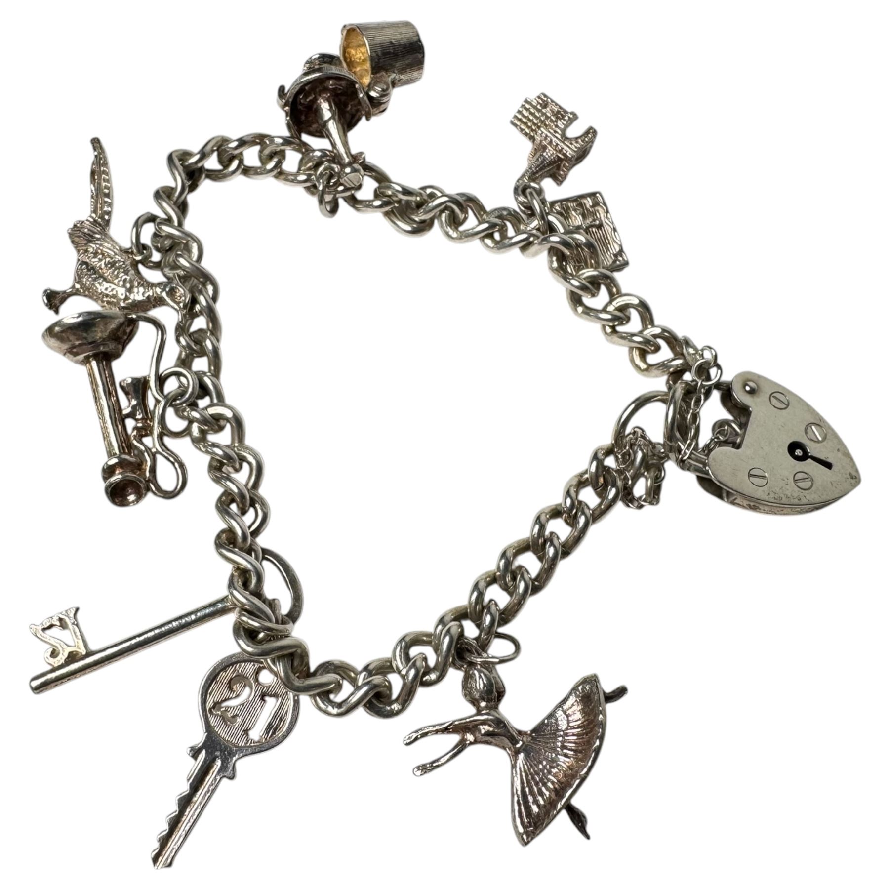 Three 9ct gold brooches, including two stone set examples, silver charm bracelet, amber type beads and gilt metal jewellery