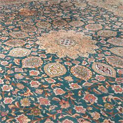Persian Tabriz type carpet, the teal ground decorated with central medallion, radiating palmettes and dense floral scrollwork, within multiple floral borders