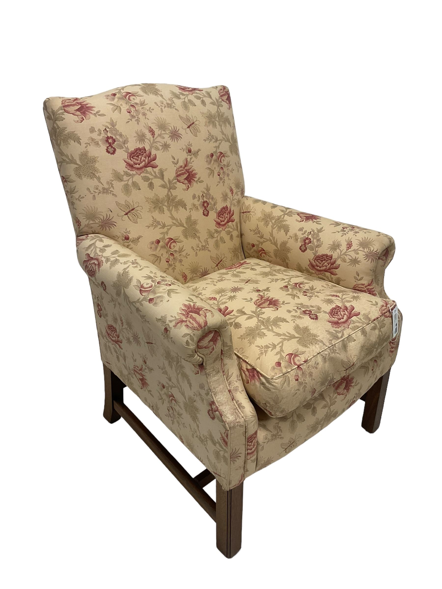 Peter Dudgeon - Georgian design mahogany framed armchair, shaped cresting rail over sprung back and seat flanked by rolled arms, upholstered in floral patterned fabric with matching seat cushion, on square supports joined by stretchers
Provenance: From the Estate of the late Dowager Lady St Oswald