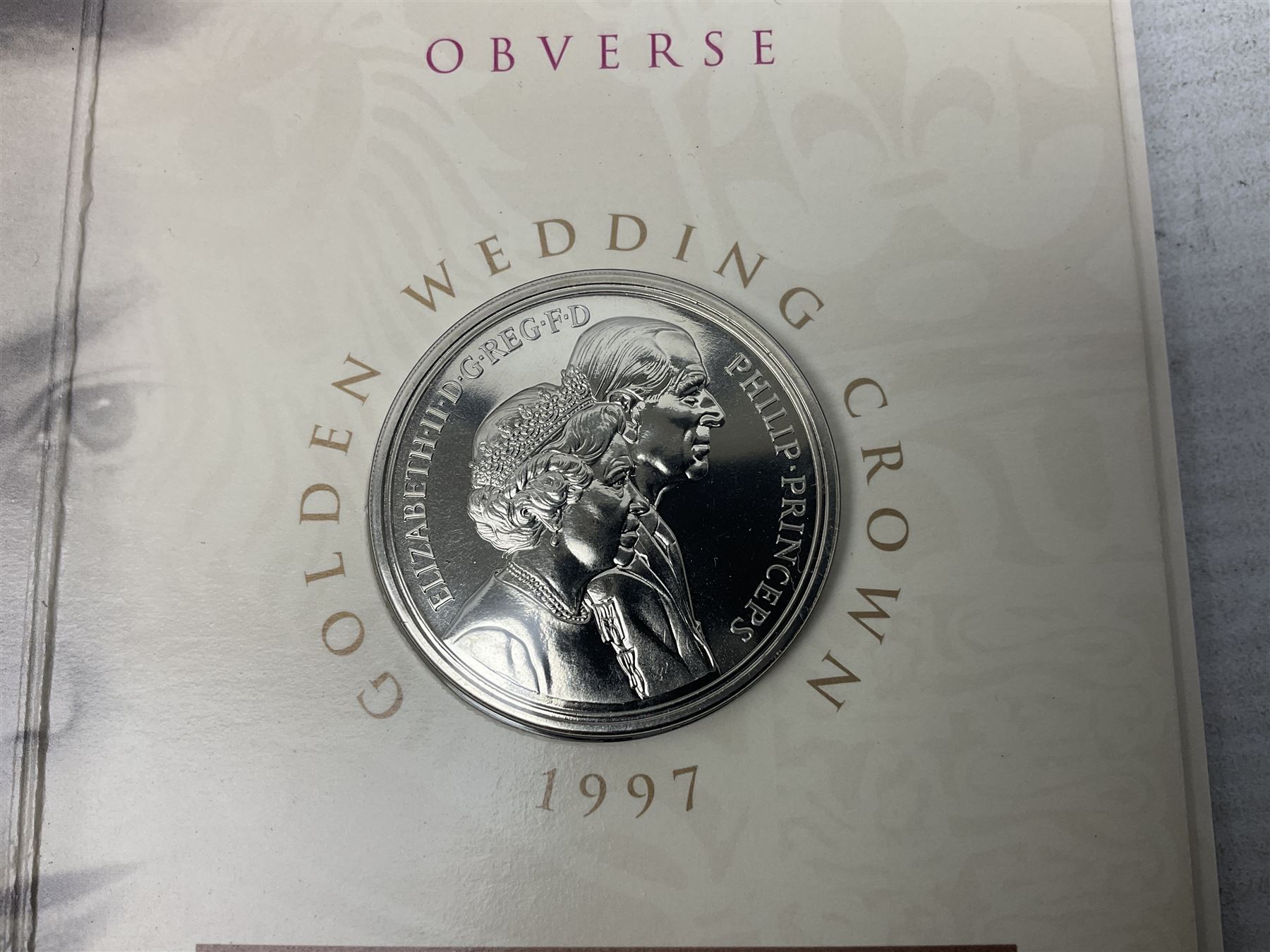 The Royal Mint United Kingdom 1984 brilliant uncirculated coin collection, 1997 and 2001 commemorative crown coins, 1997 old round one pound, all in card folders and four sterling silver medallic first day covers from the 'Great Britons' collection housed in a blue folder