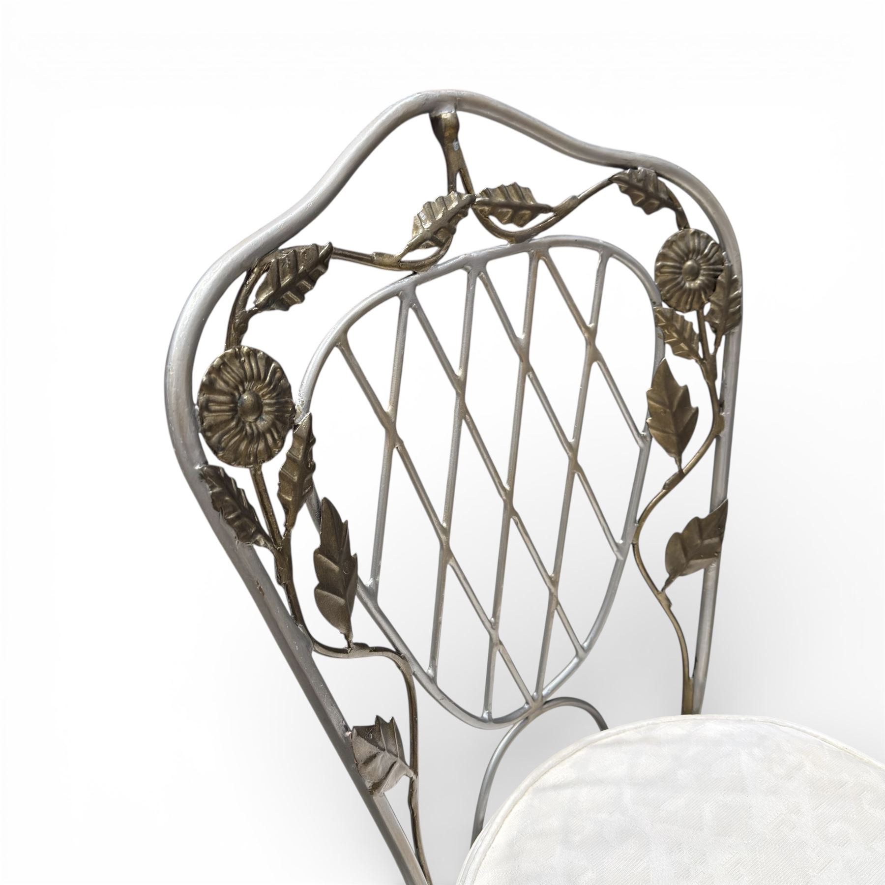 Wrought iron garden dining table with leaf decoration, and set of four matching chairs