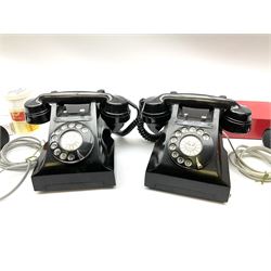 Two vintage black Bakelite telephones, with rotary dials, together with two Bakelite handsets. 