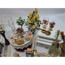 Dolls house furniture, including pianos, fireplace, plants, flower arrangements, tables, chairs, six figures and a collection of instruments and other accessories