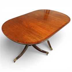 Arthur Brett & Sons - Regency design mahogany extending dining table and eight chairs, the oval top with rounded ends and two extension leaves, raised on twin pedestal supports with swept legs terminating in brass caps and castors, accompanied by a set of eight chairs comprising six single chairs and a pair of carvers, the chairs with curved backs and horizontal splat rails, upholstered seats, sabre legs and scrolling arms to the carvers
(Extends to 252cm)
(Chairs H 86cm, W 52cm)