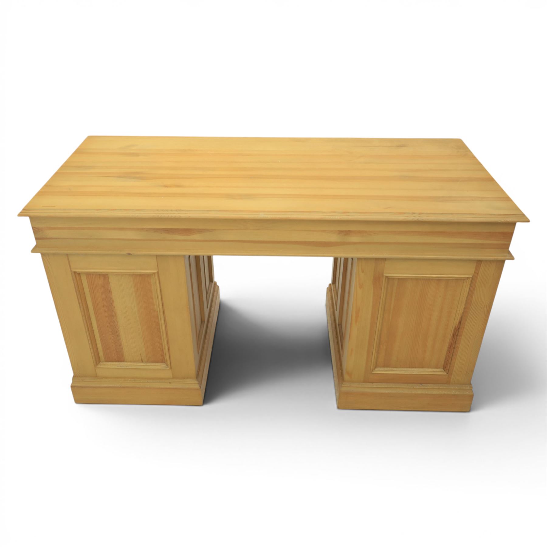 Solid pine twin pedestal desk, fitted with nine drawers, fielded panelled sides