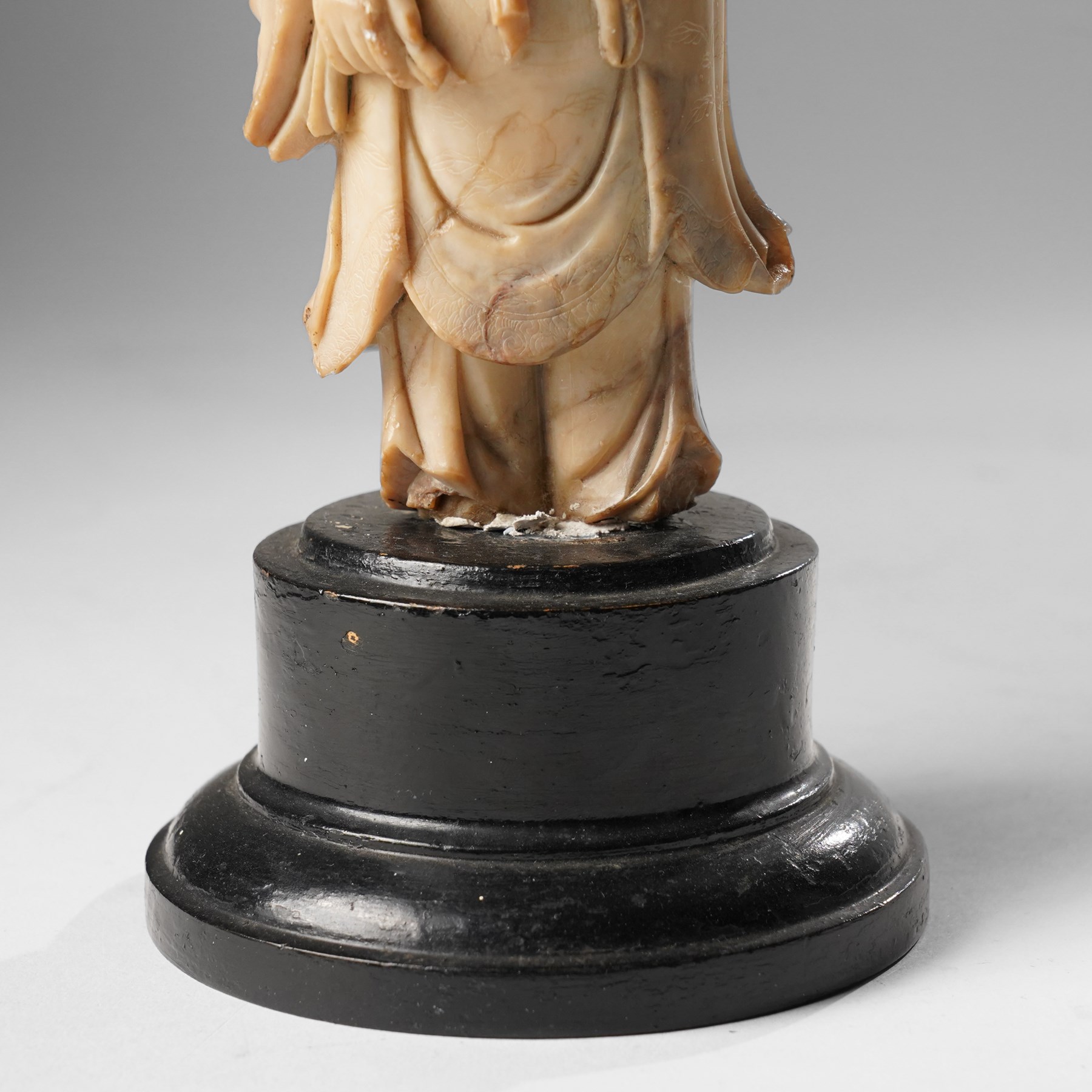 Soapstone carving of an immortal, possibly Zhongli Quan, on ebonised wooden base, including base H22cm