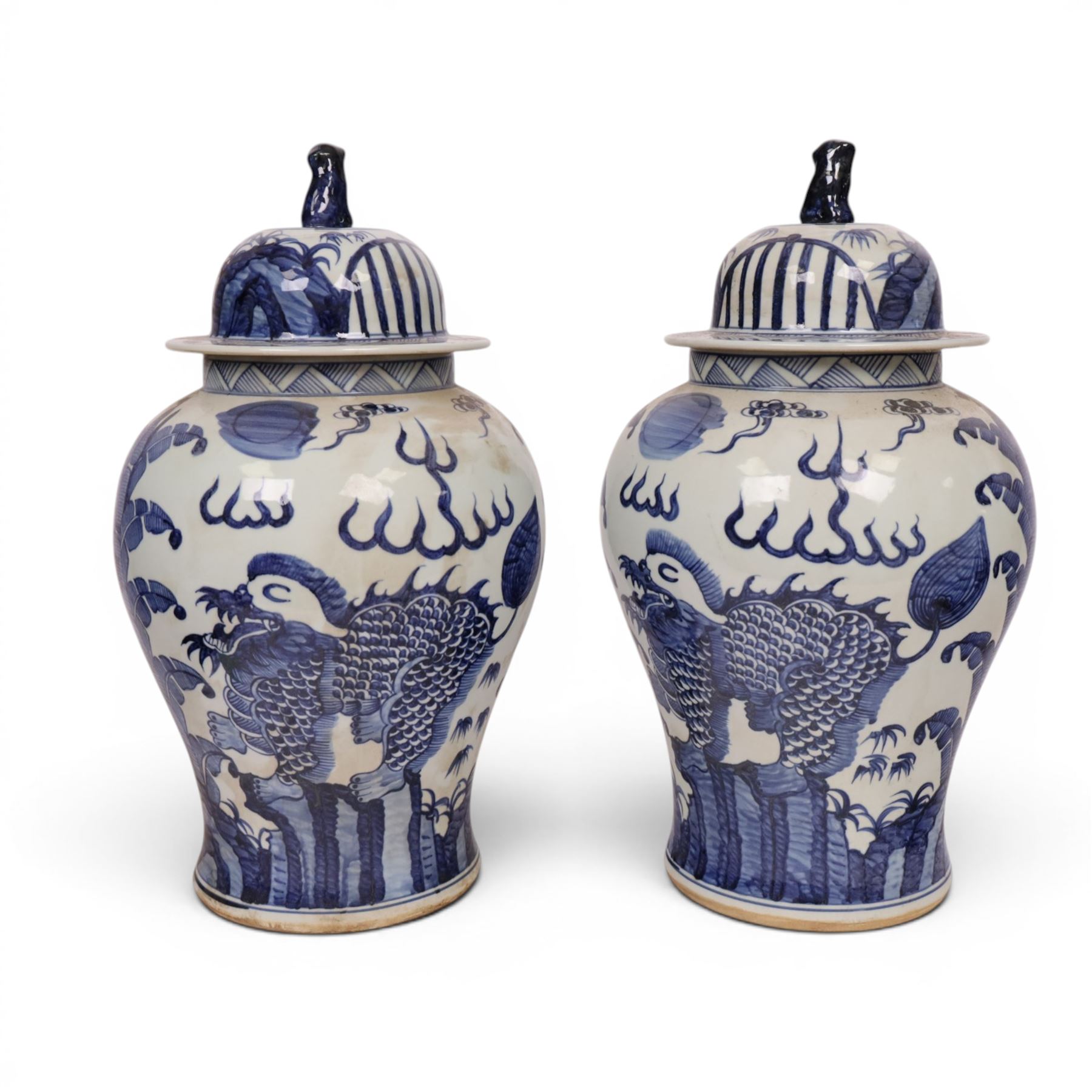 Pair of blue and white Chinese vase and cover, of baluster form, decorated with dragons, the cover with a fo dog finial, H15cm