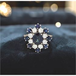 18ct white gold sapphire and diamond cluster ring, single oval cut sapphire of approx 1.85 carat, surrounded by eight round brilliant cut diamonds and eight round cut sapphires, stamped Graff, total sapphire weight approx 3.40 carat, total diamond weight approx 1.35 carat