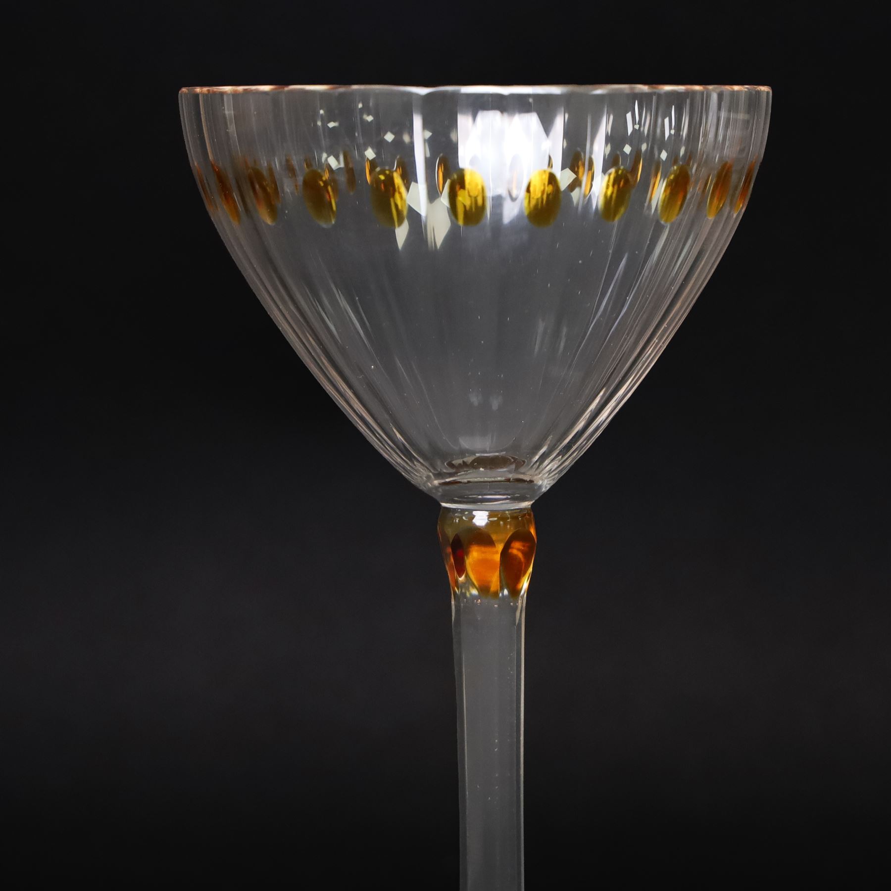 Otto Prutscher (1880-1949) - pair of early 20th century crystal wine glasses with citrine coloured ovals to the bowl and yellow stained at the top of the stem on a trumpet shape foot H21cm
Notes: The glasses were probably made at the Meyr's Neffe glassworks, Adolf, Bohemia for the retailer E Bakalowits & Sohne, Vienna circa 1909 
