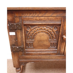  Jacobean style oak sideboard, two carved panel doors flanking two drawers, turned supports joined by stretchers, W146cm, H84cm, D44cm  