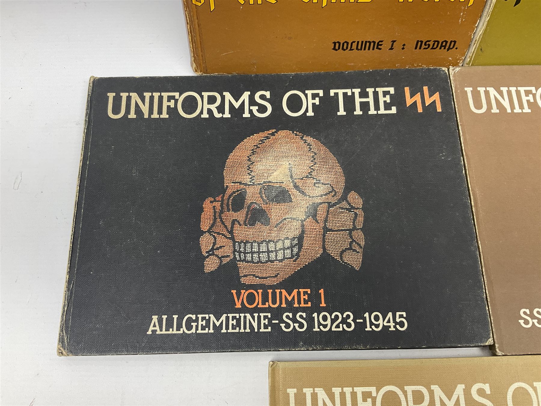Military Collectors Service: set of three books on WWII German uniforms and badges; and Mollo Andrew: Uniforms of the SS. Volumes 1,4,5,6 & 7 (8)