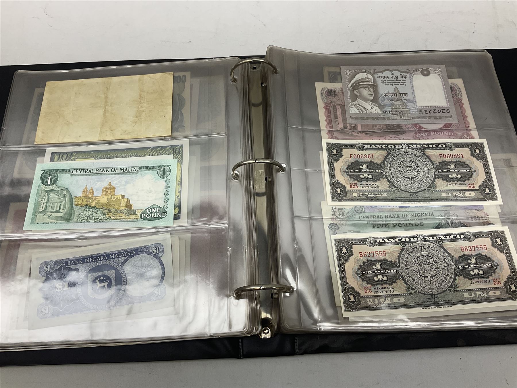 World banknotes, including Queen Elizabeth II The States of Jersey one pound 'DB202703', five pounds 'BB527762' and ten pounds 'AB651481', reserve bank of New Zealand two dollars '1L3 741894', King George V Straits Settlements one dollar 1st January 1935 'F/83 28924', various Bank of England notes etc, housed in two ring binder albums