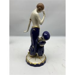 Royal Dux Art Deco figure group of Turkish dancing girl with a young boy beside her holding a casket, decorated with gilding, raised upon scalloped edge plinth base, with applied pink triangle and impressed 2948 beneath