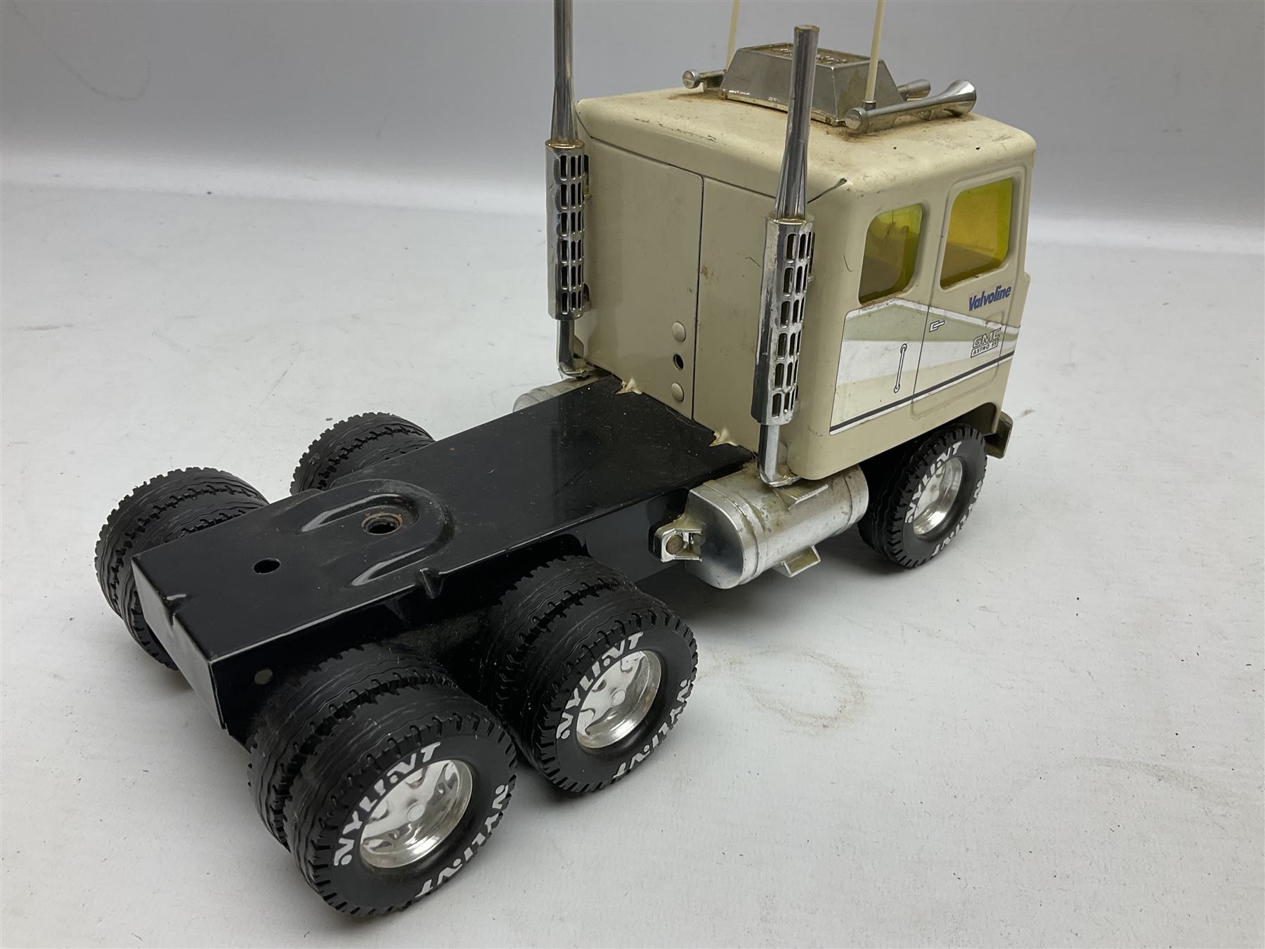 American Nylint large scale tin-plate car transporter L59cm carrying a Testor Toys plastic car; Tonka tin-plate mobile crane; boxed Sarony Cigarettes tin-plate roulette game with rules; and Japanese style tin-plate box, the lid inset with a revolving poker dice game (4)