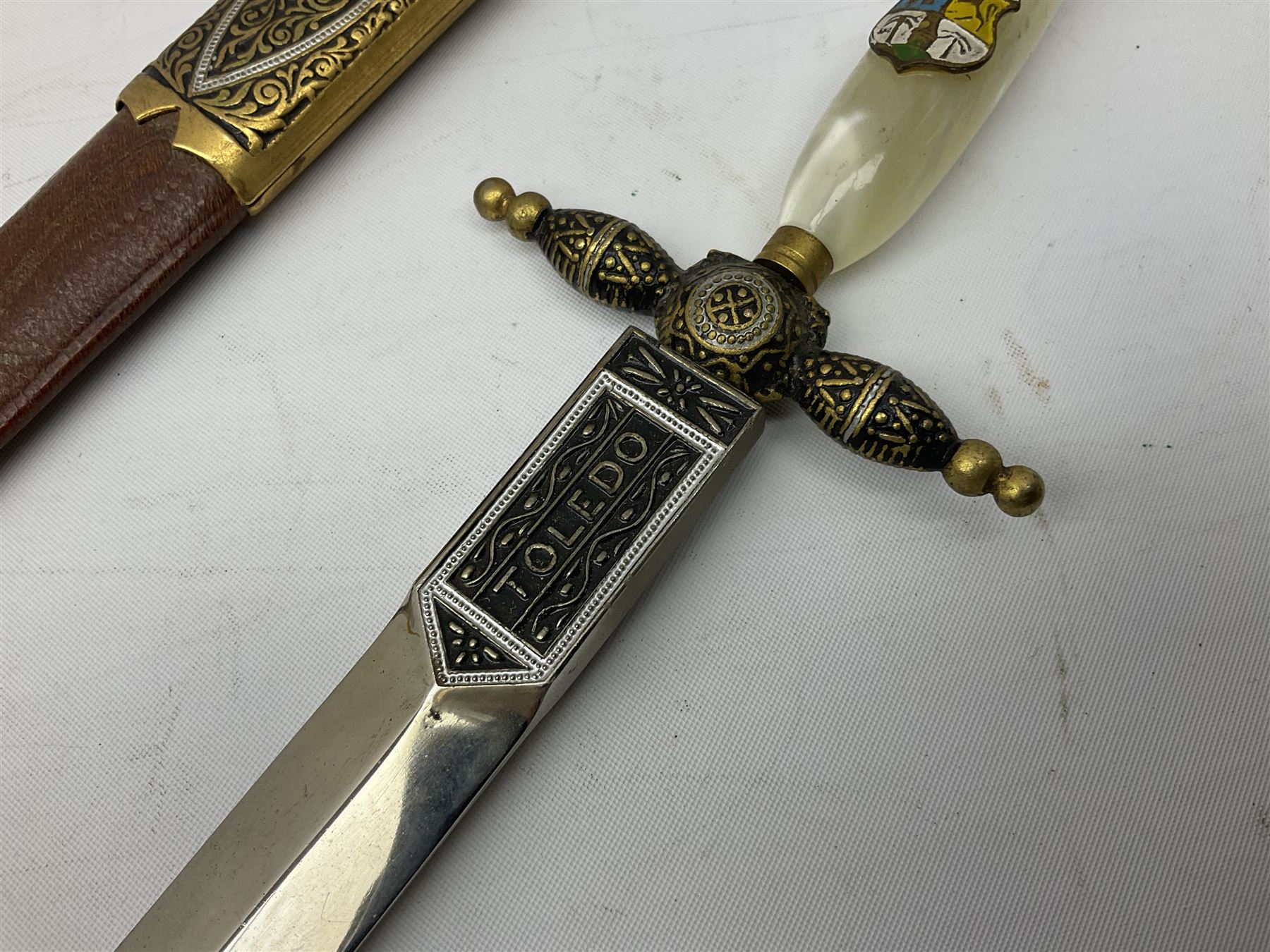 Malayan Kris dagger, the 31.5cm double edged straight heavy damascus blade with copper ferrule; carved hardwood grip; in large wooden throated scabbard with floral decorated white metal covering L47.5cm overall; a kris blade with adapted antler grip; and five various small daggers/letter openers (7)