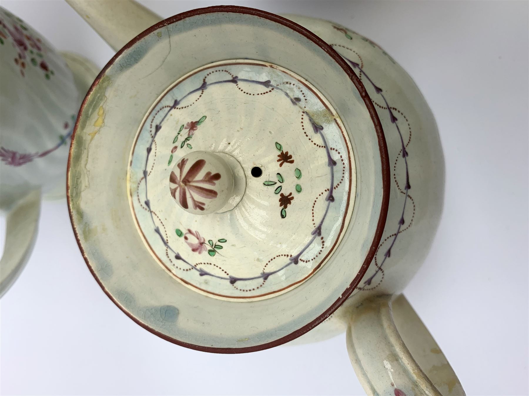 Two19th century relief moulded Castleford teapots, and lidded sucrier, largest teapot H14.5cm, together with three 18th century New Hall type teapots, an early 18th century saucer, and an 18th century blue and white bowl.
