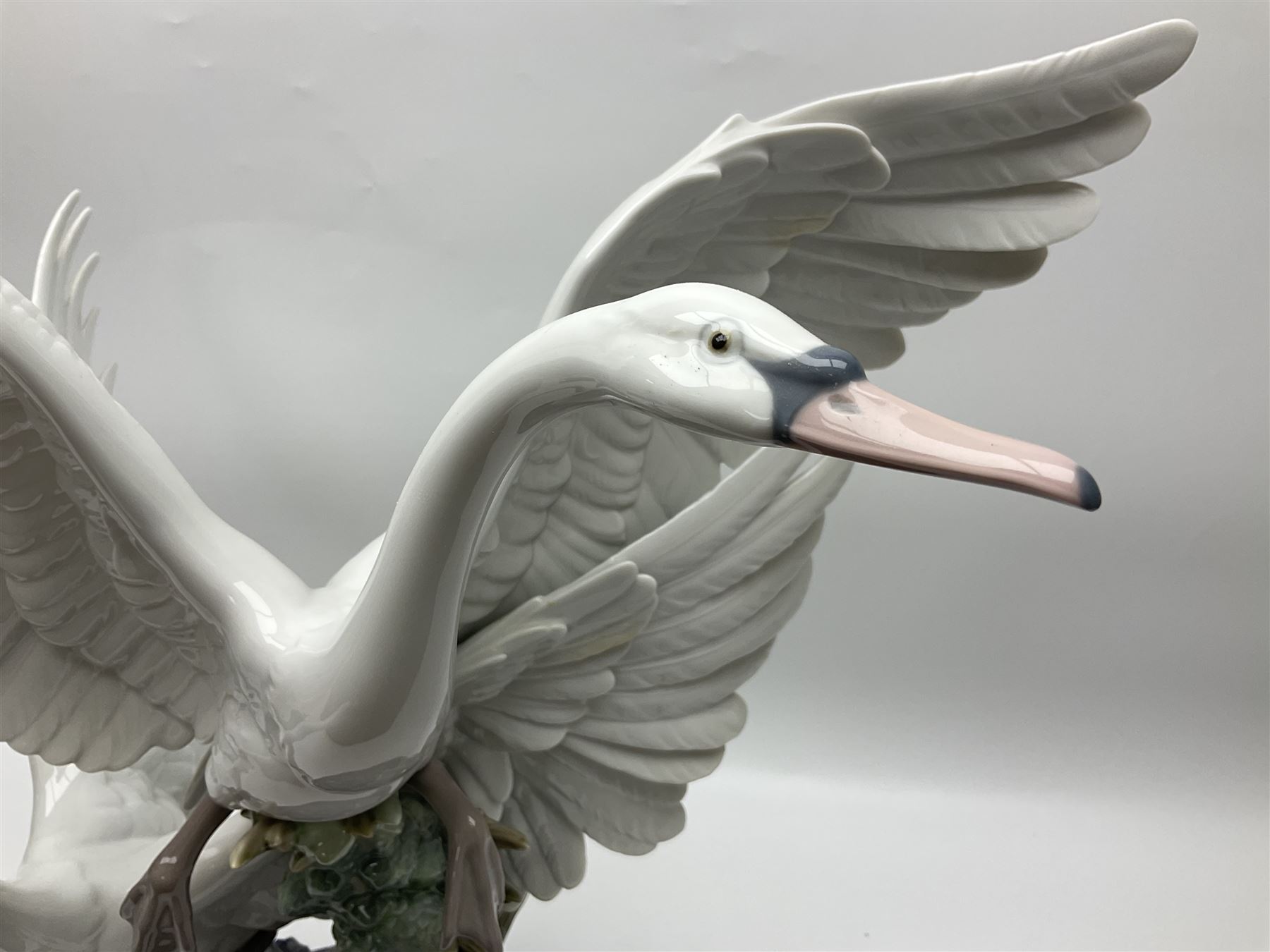 Large Lladro figure group, Swans Take Flight, modelled as two swans upon raised on circular wooden plinth, sculpted by Salvador Debon, H68cm