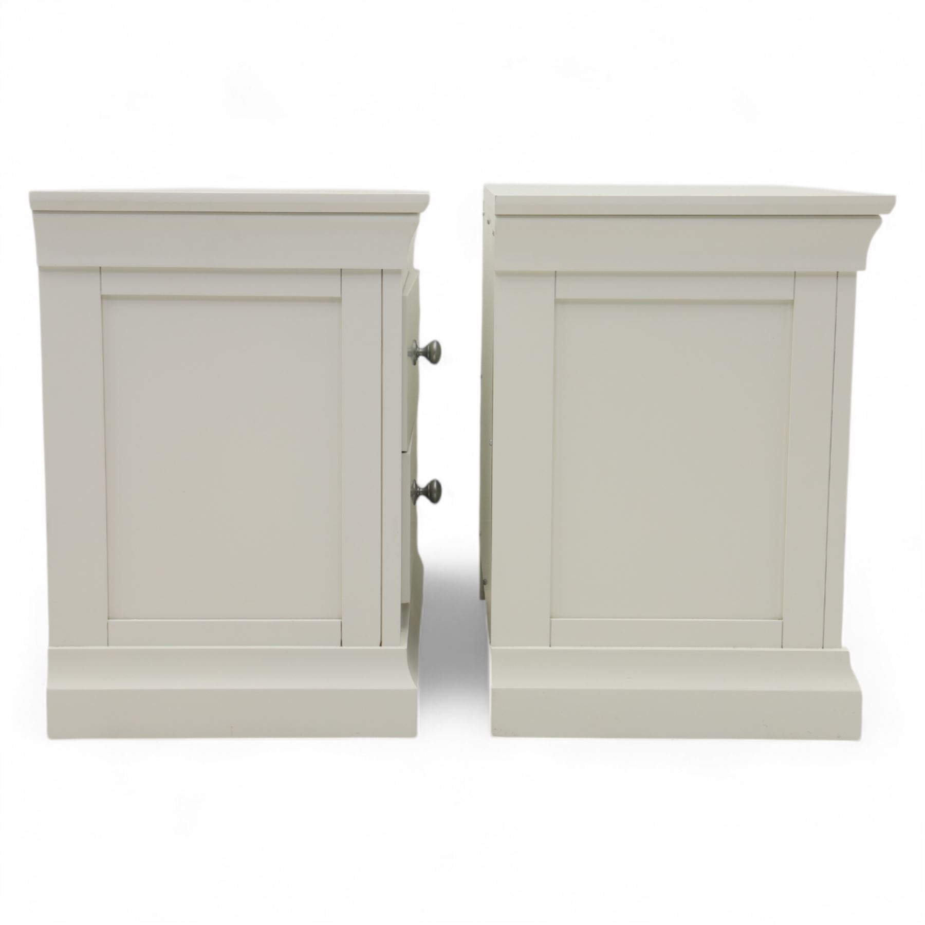 Coxwold Company - pair of white painted jumbo bedside cabinets, with two deep drawers and chrome knob handles,  shaped apron base