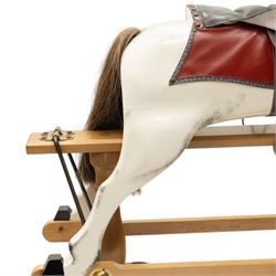 Late 20th century polychrome painted rocking horse, modelled in dapple grey finish with real hair mane and tail, leather tack and saddle, stirrups, raised on a natural wood safety trestle base
