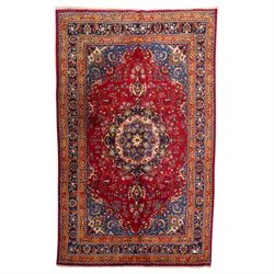 Persian Kashan hand-knotted rug, madder red ground centred by circular floral medallion wi...