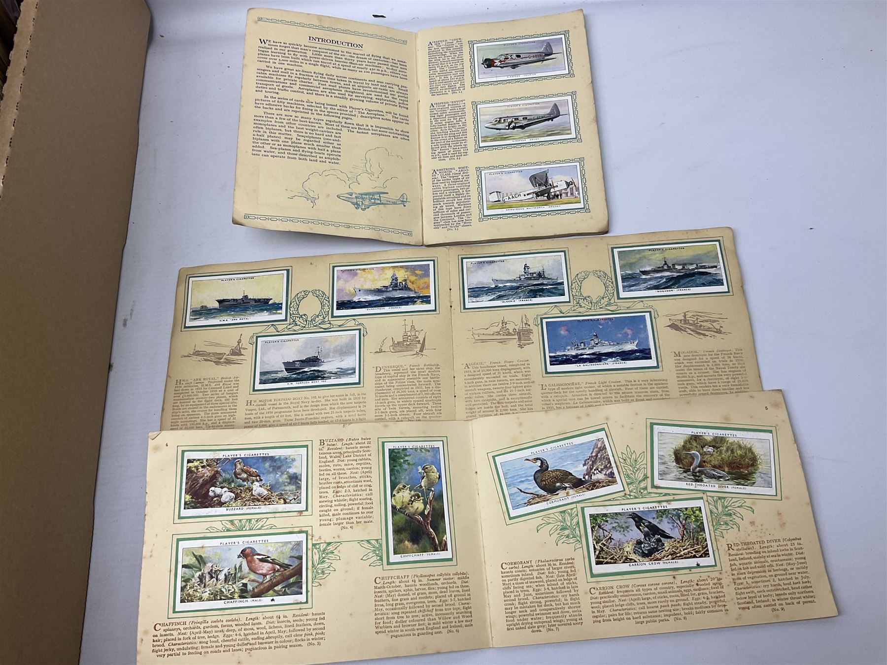 Quantity of cigarette and trade cards, housed in albums and loose, by W.D. & H.O. Wills, John Player & Sons etc, including cycling, garden hints, Britain's railways, dogs etc and various empty vintage cigarette card albums, in two boxes