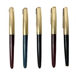 Five Parker fountain pens with gold caps, to include 65 Consort Insignia with rolled cross hatch gold cap, two Parker 51 fountain pens in burgundy with 12ct rolled gold caps, together with two further 51 examples in blue and black, all with stamped lids