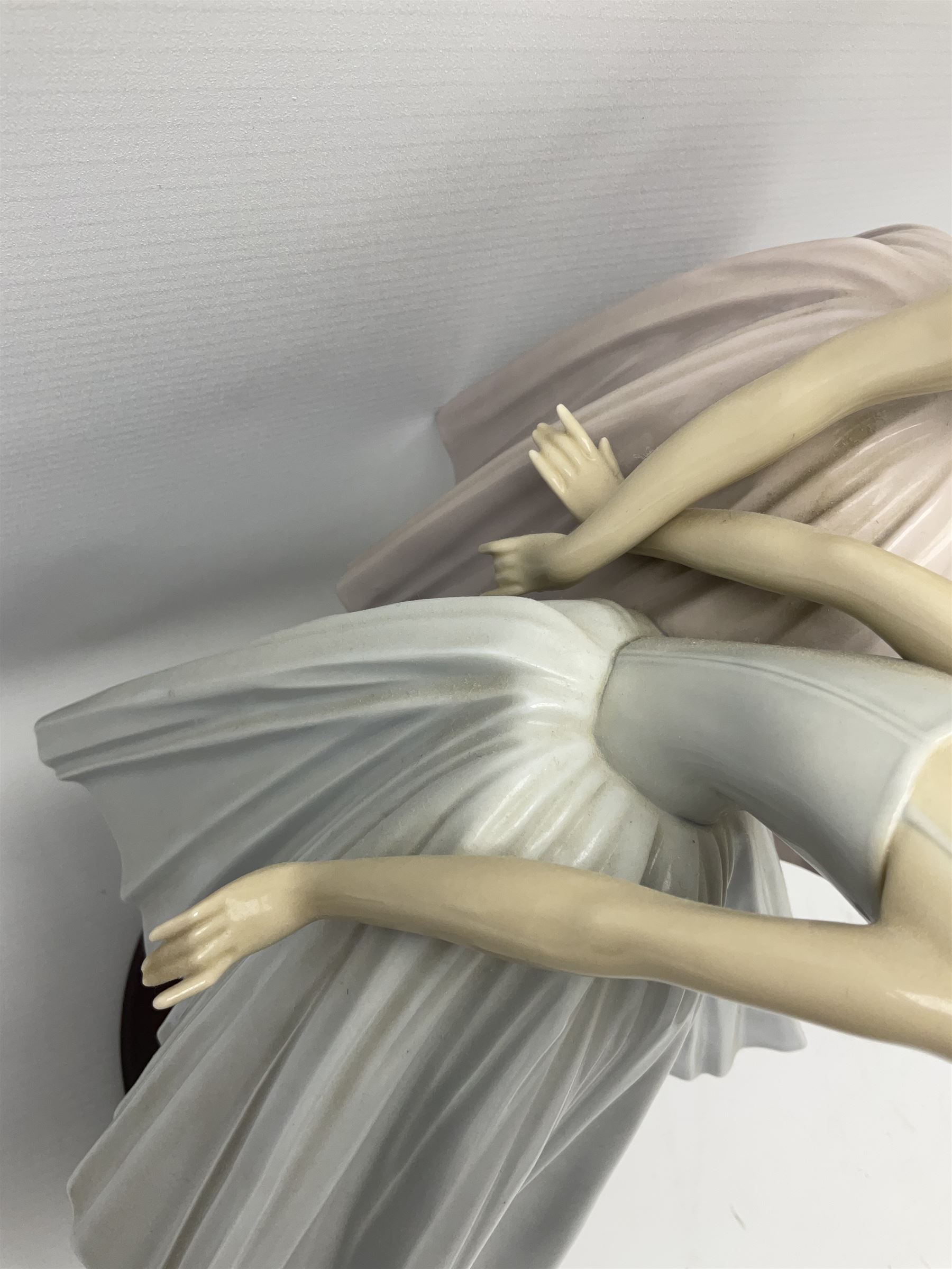Lladro figure group, 'Merry Ballet', modelled as two ballerinas in dancing pose, raised on a turned socle base, no. 5035, printed marks beneath, H49cm