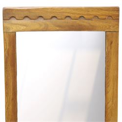 In the manner of  Yorkshire Critters - oak framed rectangular wall mirror, plain frame with carved arcade decoration to the cresting rail