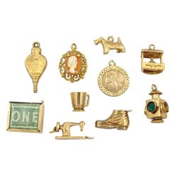 Ten 9ct gold pendant / charms including wishing well, West Highland terrier, boot, lantern, sewing machine and money box