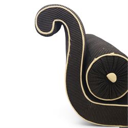 Victorian ebonised chaise longue, upholstered in black fabric with scroll headrest and bolster cushion, rectangular seat with rounded corners, raised on turned supports terminating in brass and ceramic castors