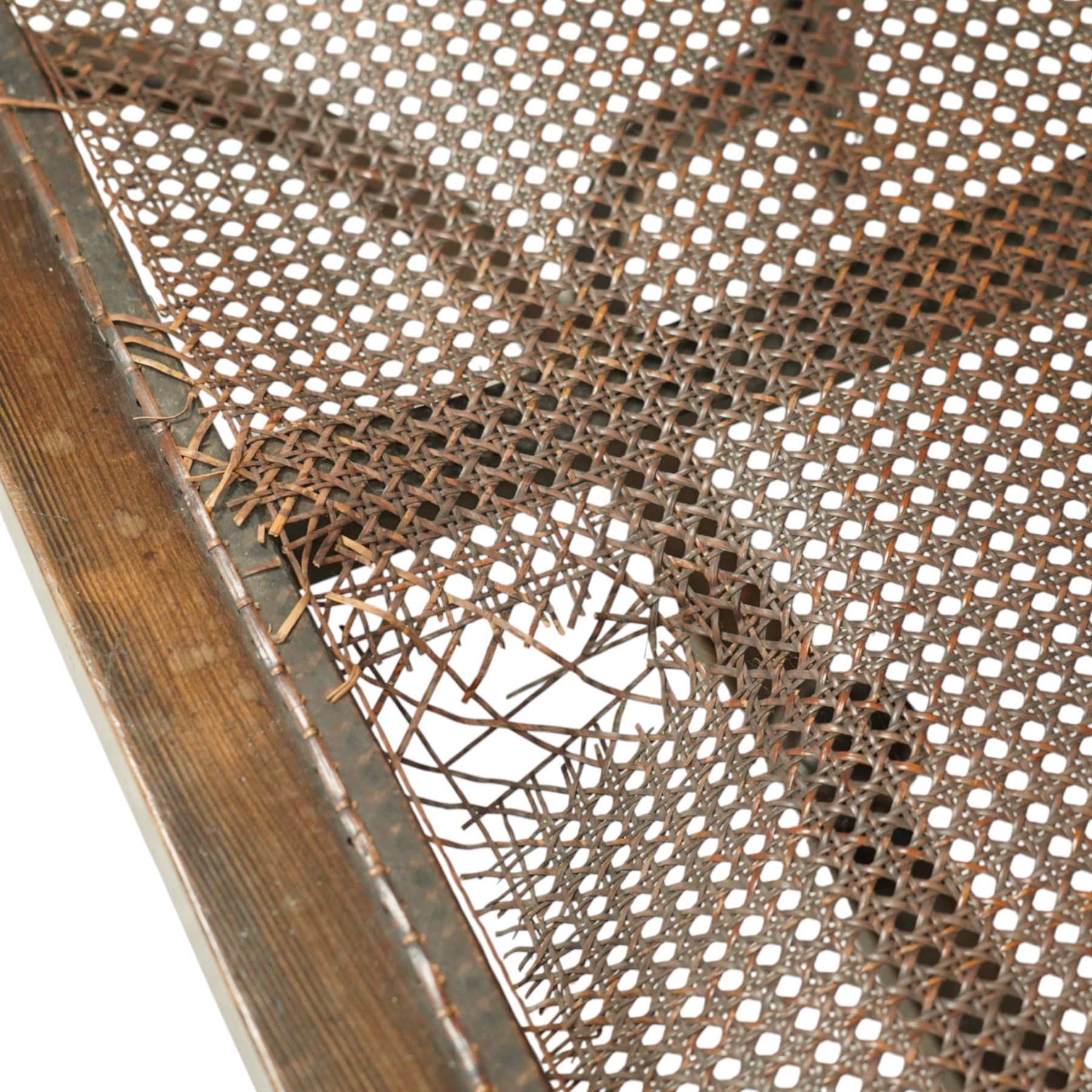 20th century bergère two seater settee, with shaped curved top rail and downswept arms, the back and seat fitted with woven cane panels, supported by turned uprights and legs united by a carolean stretcher 