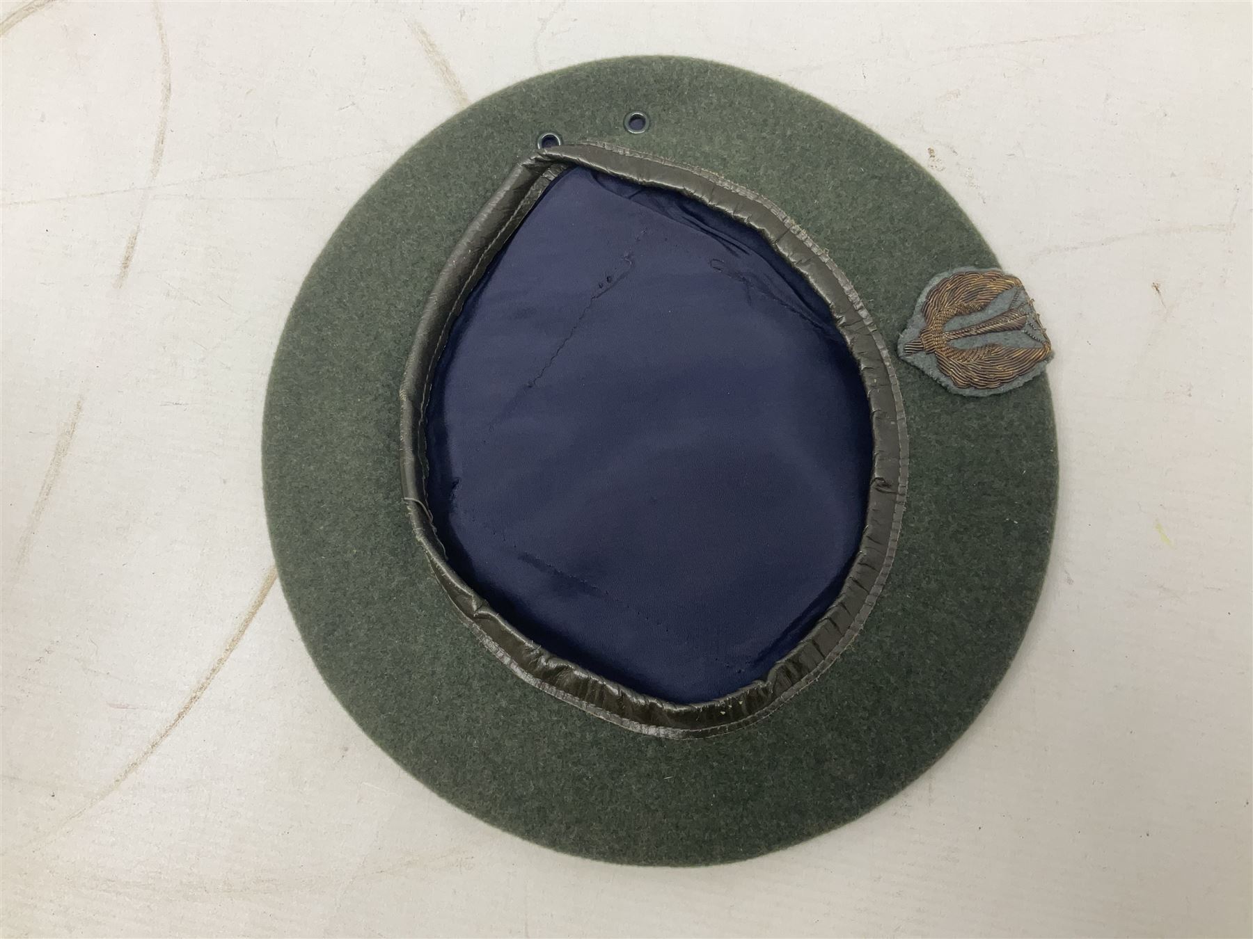 Four paratrooper berets - Russian, Italian, British and Foreign Legion; all with badges (4)