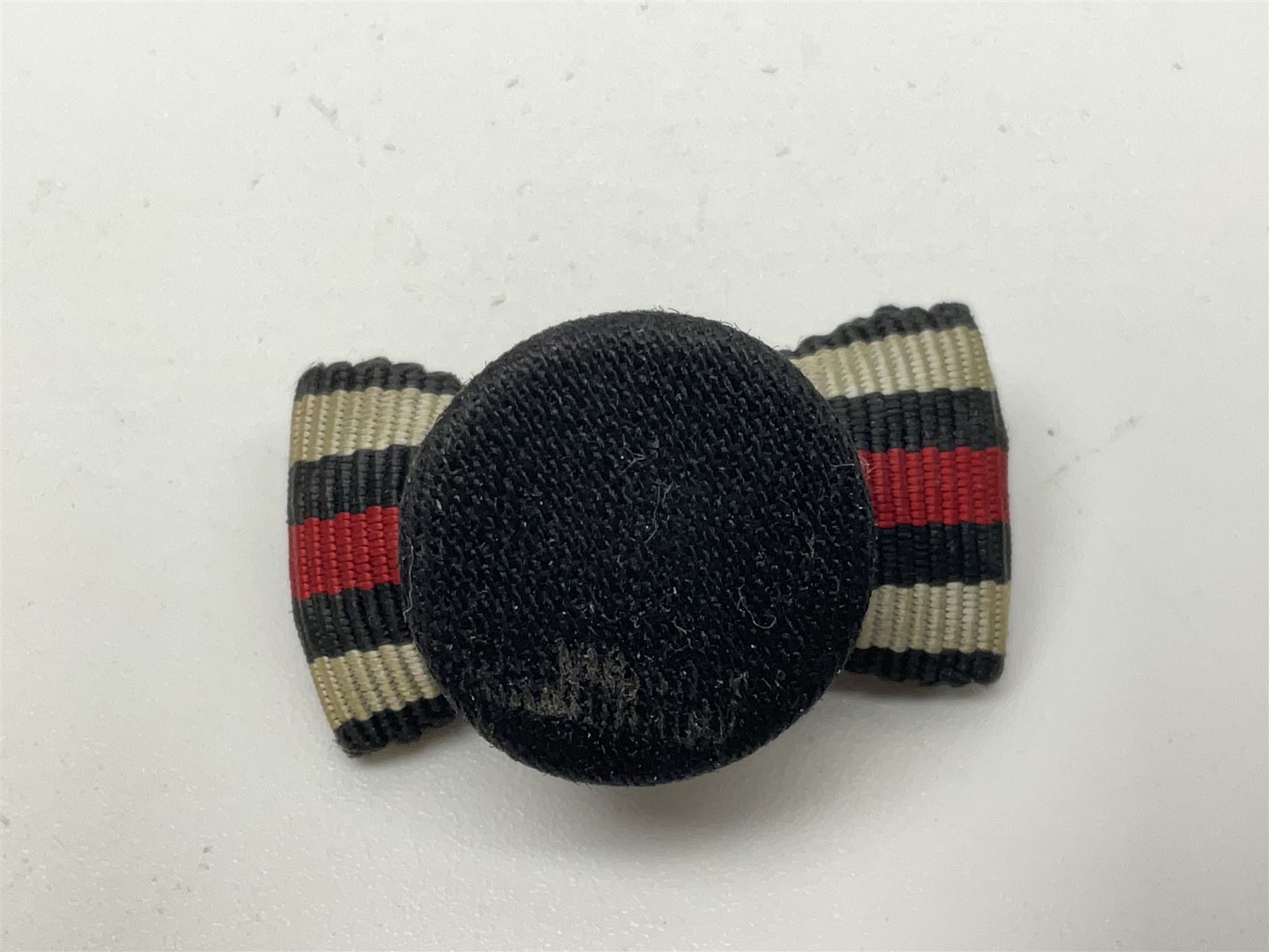 Four German awards - pre-WW2 two-position button hole ribbon for 1914 Iron Cross; WW1 wound badge open back cut-out version with silvered finish; miniature version Mother's Cross with ribbon bow; and The Eastern Medal, officially the Winter Battle in the East 1941–42 Medal (4)