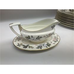 Royal Worcester June Garland pattern tea and dinner wares, comprising thirteen dinner plates, twelve dessert plates, twelve side plates, six twin handled soup bowls and six saucers, six small bowls, sauce boat and stand, thirteen teacups and fifteen saucers, open sucrier, and milk jug