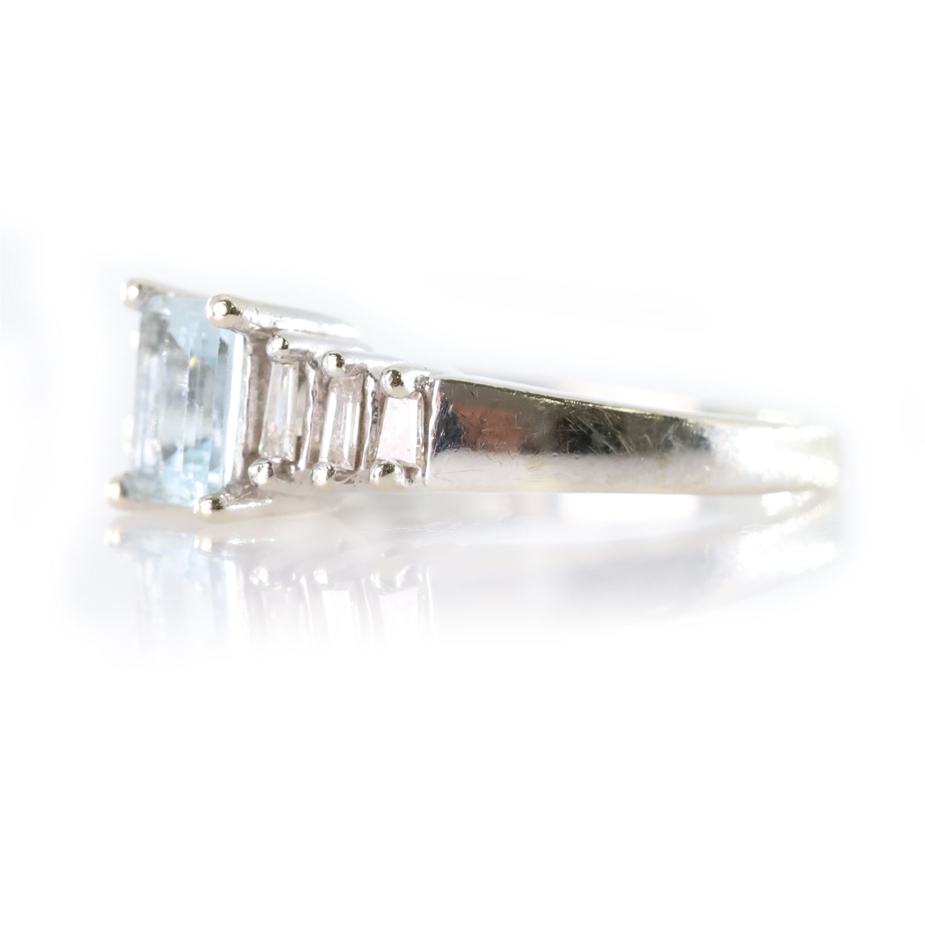 10ct white gold aquamarine and diamond ring, single octagonal cut aquamarine of approx 0.45 carat, with three tapered baguette cut diamonds set either side, stamped