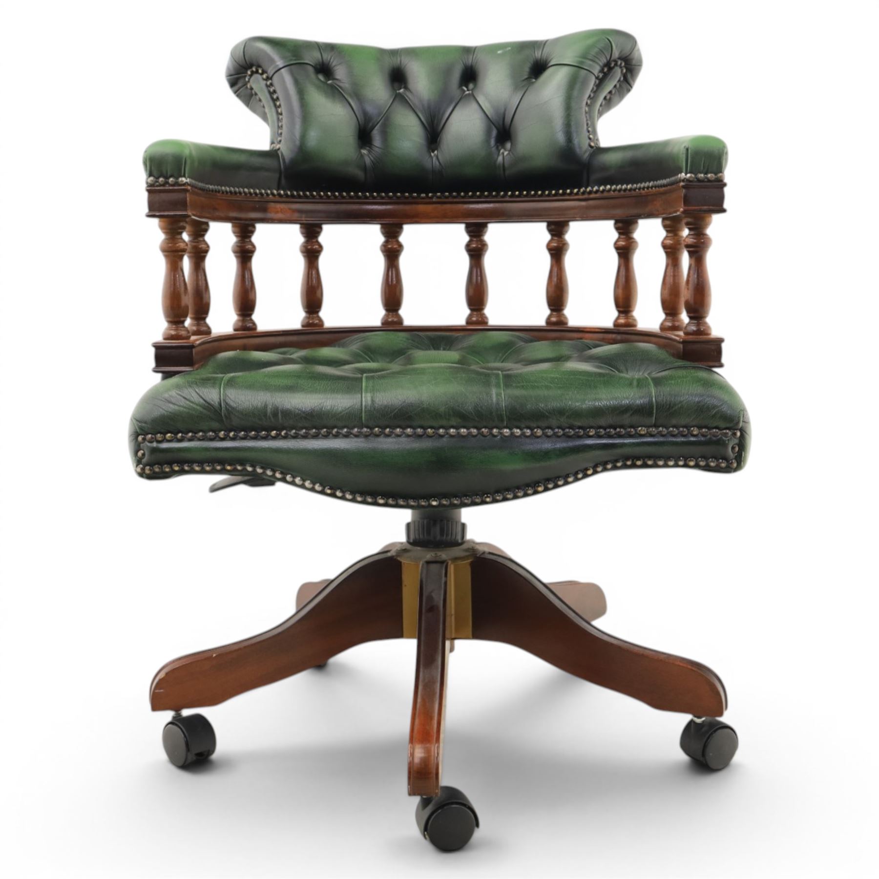 Captains swivel desk chair upholstered in buttoned green leather, five point star base raised on castors