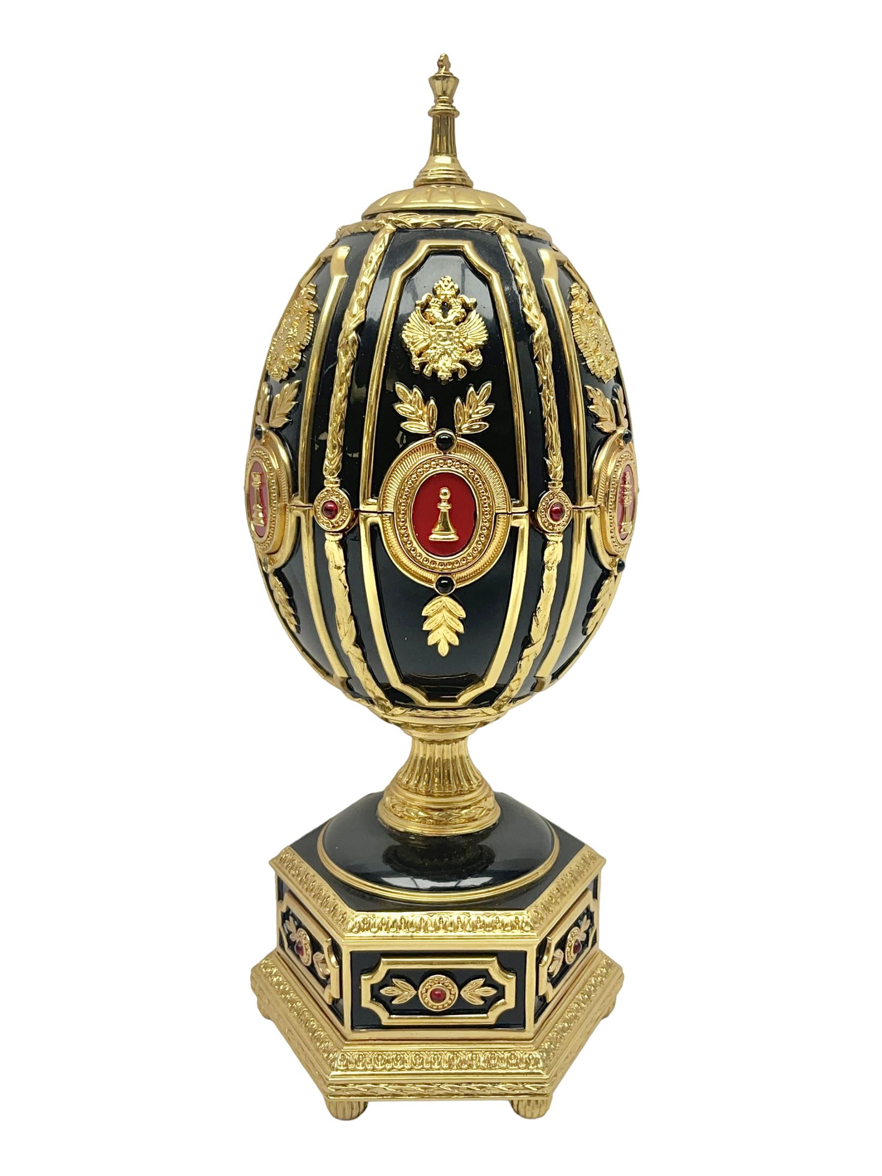 Franklin Mint House of Faberge; The Imperial Jeweled Egg Chess set, the egg opening to reveal a chess board, with a draw to the hexagonal base holding the miniature chess pieces, H23cm 