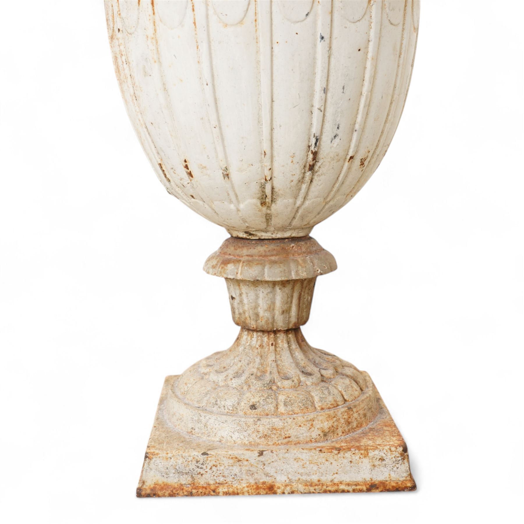 Pair of Victorian white painted cast iron lotus garden urns on stop fluted and lobed plinth bases