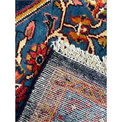 Persian Veis indigo ground carpet, the field with large pole medallion decorated with Herati motifs and surrounded by floral sprays, crimson ground border with repeating cross motifs and stylised flower heads, within guard stripes 