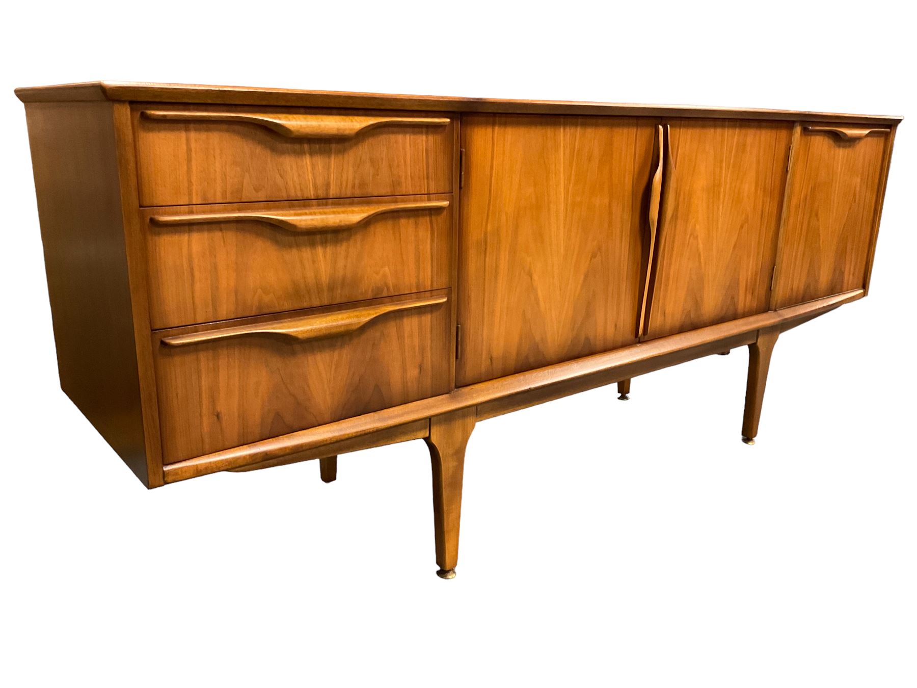 Jentique - mid-20th century teak sideboard, fitted with three drawers, double cupboard and fall front cupboard, raised on tapering supports