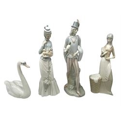 Lladro 'Walk With the Dog' figure no. 4893, together with Lladro swan figure, Porceval figure of a gentleman with a bird perched upon his hand and a further of a lady with flowers beside a basket, all with marks beneath, tallest H40cm