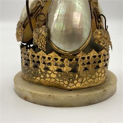Victorian evening dinner bell, with three mother of pearl shells, floral and grape gilt decoration, and bird finial, raised upon a circular soapstone base with gilt pierced gallery, H14cm